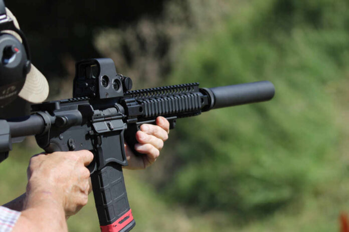 Man,Firing,Machine,Gun,With,Silencer,Bumpstock
