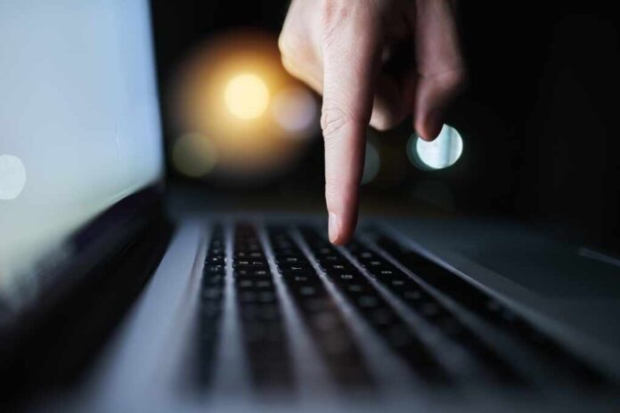 Hacker,,Night,And,Finger,Of,Person,On,Computer,For,Malware