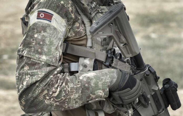 Soldier,With,Assault,Rifle,And,Flag,Of,North,Korea,On