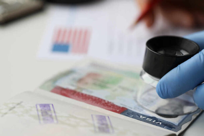 Specialist,With,Loupe,Checking,Authenticity,Of,American,Visa,In,Passport