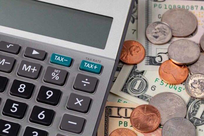 Tax,Calculator,With,Cash,Money,And,Coins.,Income,,Sales,Tax