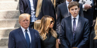 A family standing together in formal attire at a memorial service