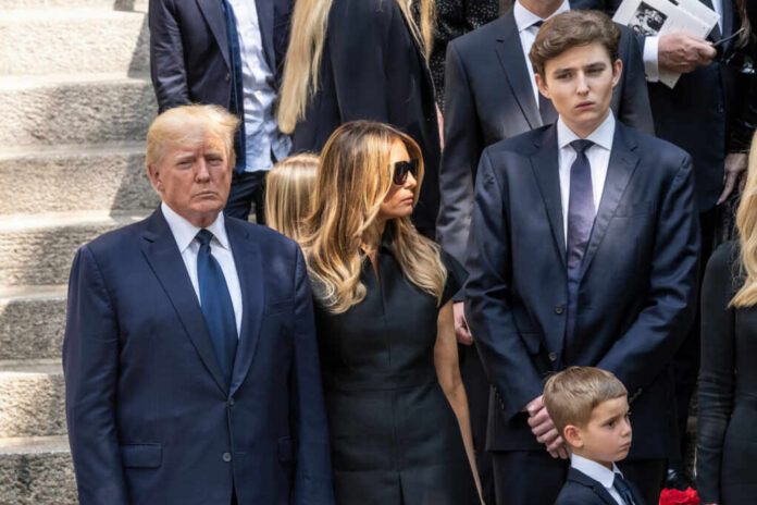 A family standing together in formal attire at a memorial service