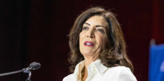 A woman speaking at a podium during a conference