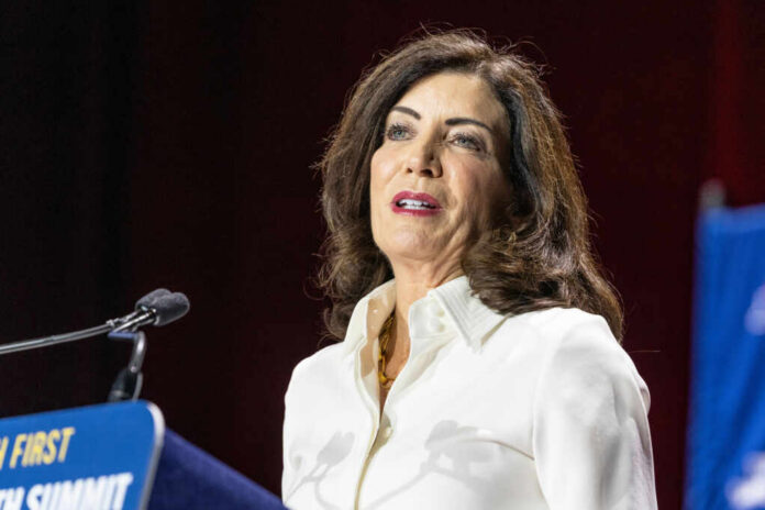 A woman speaking at a podium during a conference