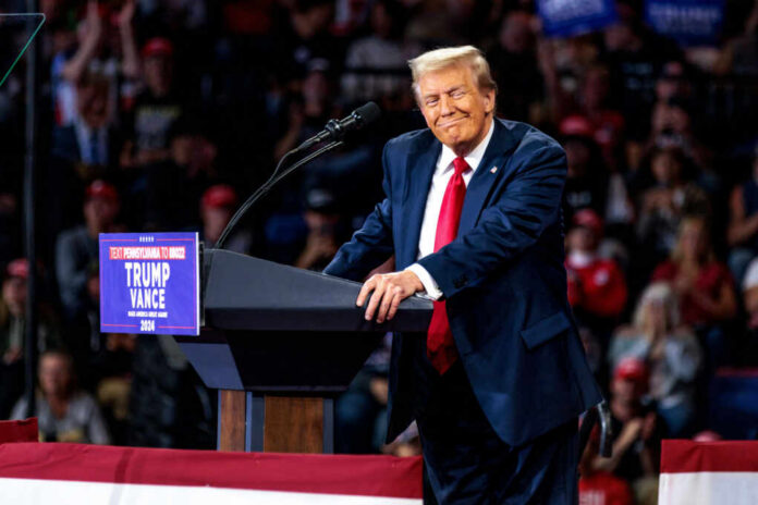 shutterstock2528583573jpg A speaker at a political rally smiling while addressing the audience