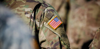 Close-up of a military uniform featuring an American flag patch