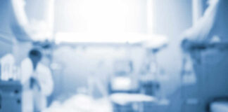 Blurred image of a medical professional in a hospital setting