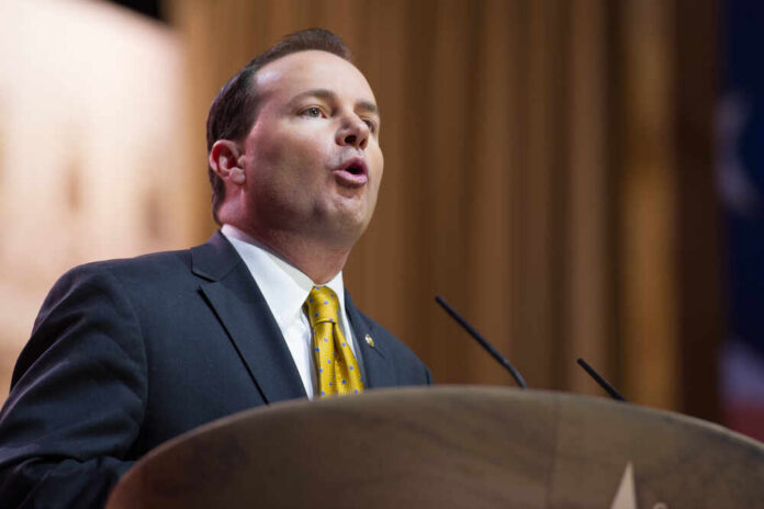 A man in a suit delivering a speech at a podium