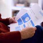 Person reviewing an energy bill with detailed information