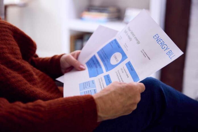 Person reviewing an energy bill with detailed information