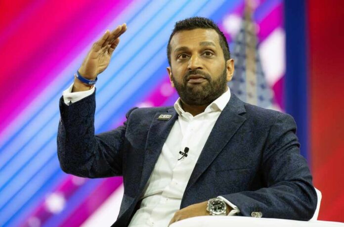 A speaker gesturing while addressing an audience at a conference