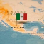 Map of North America with a flag of Mexico pinned on it