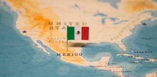 Map of North America with a flag of Mexico pinned on it