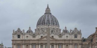 St. Peters Basilica in Vatican City with a cloudy sky and a large obelisk in the foreground