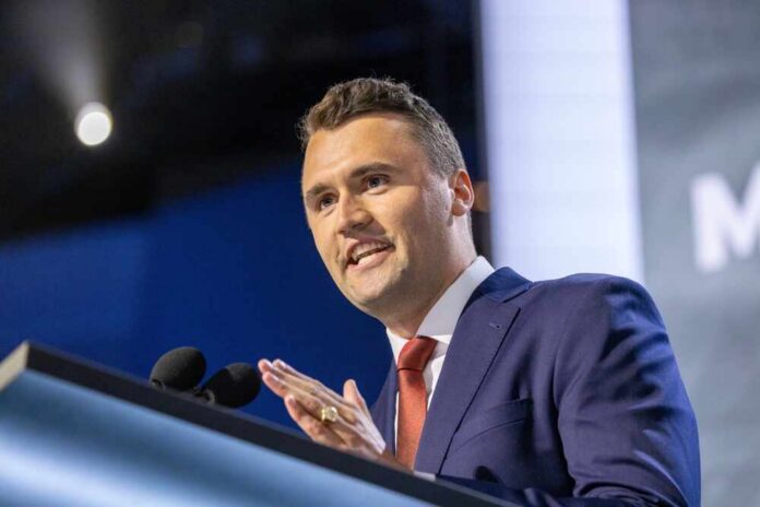 A man in a suit speaking at a podium during a conference