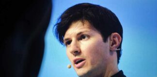 A speaker presenting at a conference with a microphone