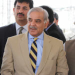 Group of men in formal attire engaged in conversation outdoors