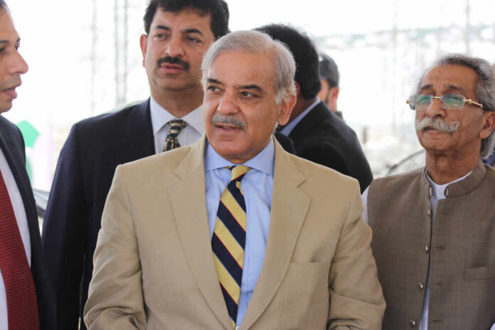 Group of men in formal attire engaged in conversation outdoors