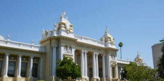 Exterior view of a historic courthouse with columns and decorative architecture