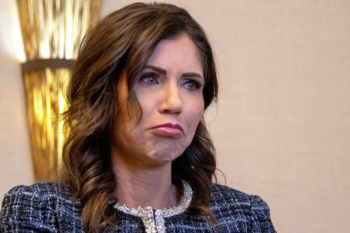 A woman with a concerned expression in a formal outfit