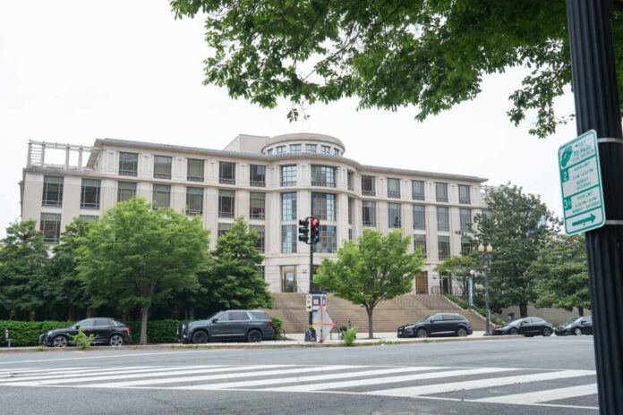 shutterstock_2152314243.jpg Modern building with trees and traffic signal in an urban setting