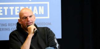 Person speaking into a microphone during an event