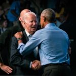 Two political leaders embracing at a public event