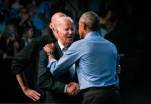 Two political leaders embracing at a public event