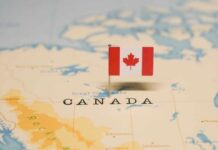 A small Canadian flag placed on a map indicating Canada