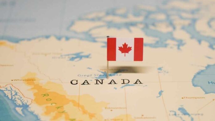 A small Canadian flag placed on a map indicating Canada