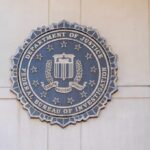 Ex Top Official’s Resignation Sparks Major Security Questions FBI seal mounted on a wall, representing the Federal Bureau of Investigation