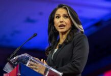 A woman speaking at a podium during a political event