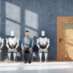AI Replacements Flop: Costly Rehiring Begins A man sitting between three humanoid robots in a waiting room for a job interview