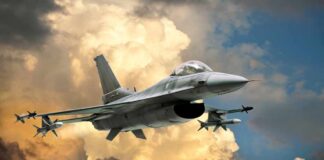 A fighter jet flying through a dramatic cloudy sky