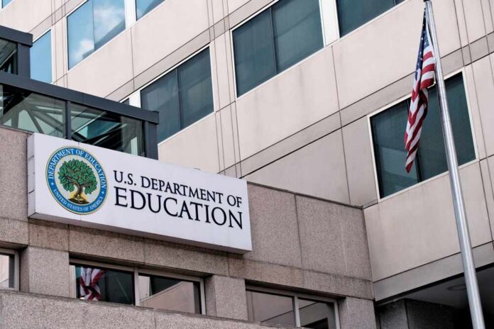 shutterstock_2512887887.jpg Exterior view of the U.S. Department of Education building with an American flag