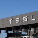 Elon Musk’s UK Energy Ambitions Trigger Political Storm Exterior view of a Tesla dealership with the logo prominently displayed