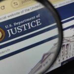 Flynn’s Case CLOSED: Mystery Payout Revealed? Close-up view of the U.S. Department of Justice website through a magnifying glass