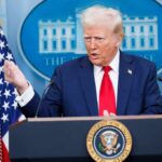 A government official speaking at a podium during a press conference