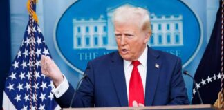 A government official speaking at a podium during a press conference