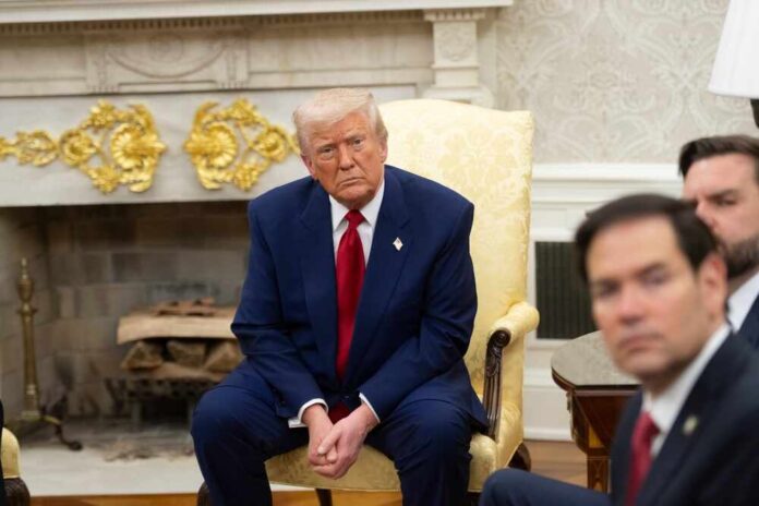 A group of political figures seated in a formal setting, with one individual looking contemplative