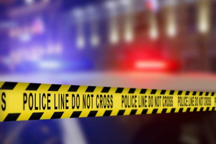 Yellow police tape reading 'DO NOT CROSS' at a crime scene