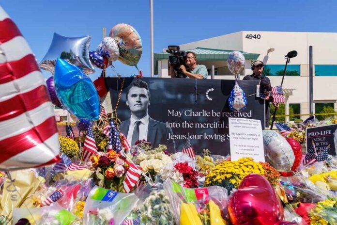 A memorial site with flowers, balloons, and a large photo honoring Charlie
