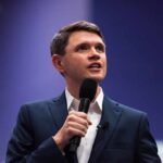 Texas Dem HIJACKS Christianity — Unbelievable Claim! A man in a suit speaking into a microphone at a conference