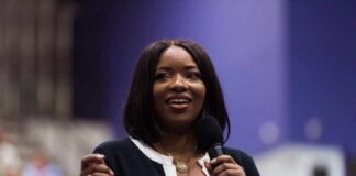 A woman speaking into a microphone at a conference