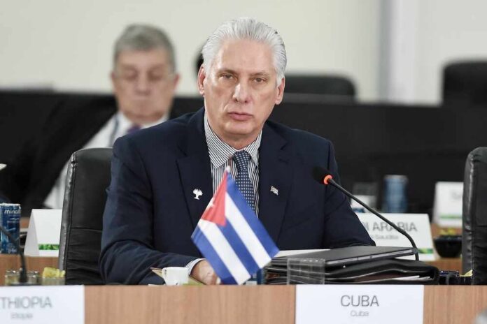 Cuban representative at a political meeting with a flag in front