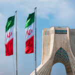 Mojtaba Khamenei’s Rise: Iran’s First Dynasty Leader Three Iranian flags in front of the Azadi Tower against a blue sky