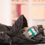 A backpack containing a mobile phone and wires, suggesting a suspicious setup