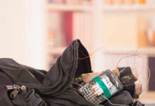 A backpack containing a mobile phone and wires, suggesting a suspicious setup