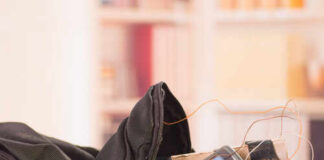 A backpack containing a mobile phone and wires, suggesting a suspicious setup